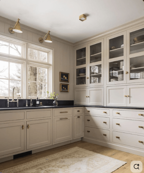 Straight ahead, down the hallway, things start to take a little detour from “traditional Colonial.” To the left you’ll find the kitchen. Bless its heart, it looks like it last saw a makeover somewhere in the 1970s. I’m talking funny little question mark island, modular vibes, the whole bit. I know it could be an amazing modern farmhouse dream kitchen, but since the photos don’t quite let me piece together the layout, I’m leaving that part up to someone braver than me.